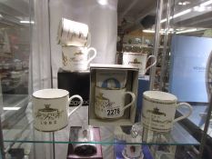 A collection of Wedgwood commemorative mugs including 2 x William 1982, 1 x Harry 1984 and 2 x