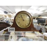 A small mahogany inlaid mantel clock.