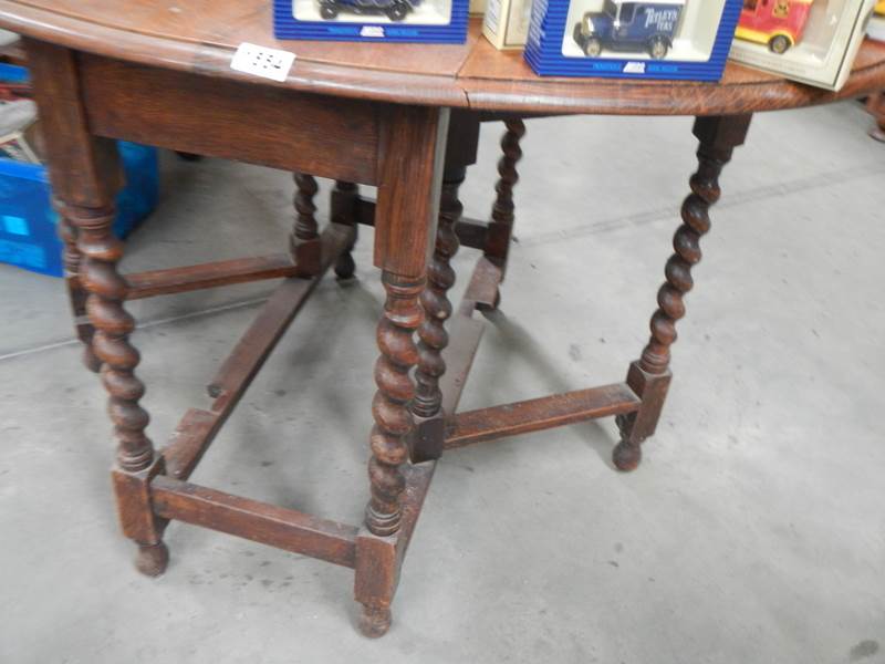 A mid 20th century oak barley twist gate leg table. COLLECT ONLY. - Image 2 of 2