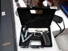 A cased BB pistol, complete