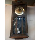 A 1930's oak wall clock. Collect Only.
