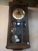 A 1930's oak wall clock. Collect Only.