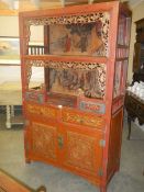 An old Chinese carved cabinet with painted back panels. COLLECT ONLY.