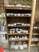 A large selection of Denby green wheat dinnerware. 6 shelves
