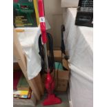 An electric Royale senior vacuum cleaner, a walking stick umbrella and a box of brushes and pans