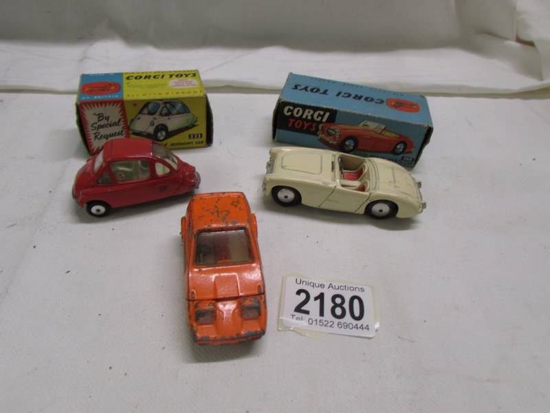 A boxed Corgi 233 Heinkel bubble car, a boxed Austin Healey 300 and an unboxed bond bug.