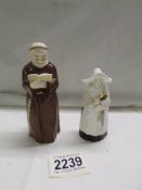 Two Royal Worcester candlesnuffers, a monk and a nun.