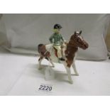 A Beswick child on a pony, in good condition.