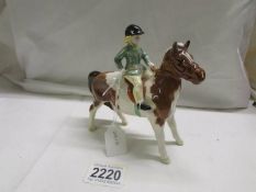 A Beswick child on a pony, in good condition.