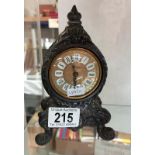 A small metal mantel clock.