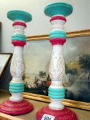 A pair of painted candlesticks