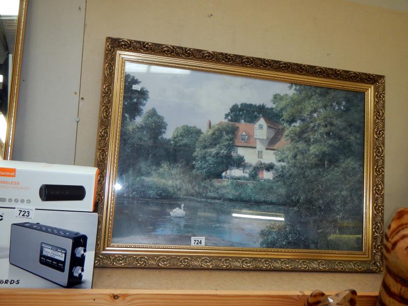 A large heavy gilt framed picture