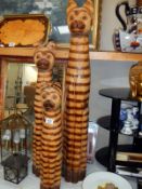 3 carved tall wooden cats