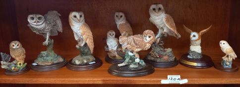 A collection of unglazed ceramic owl ornaments