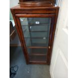 A glass 4 sided collector cabinet