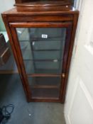 A glass 4 sided collector cabinet