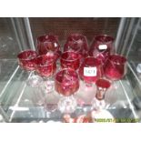 Five red glass brandy goblets and 5 other red glasses.