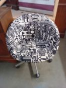 A black & white fabric jazzy pattern swivel tub chair