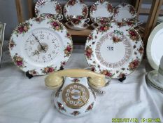 A Royal Albert Old Country Roses, clock, 1980 calendar plate and telephone.