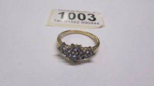 A yellow gold fifteen stone tanzanite ring size T half, 2.8 grams.