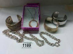 2 heavy silver bangles, a silver chain bracelet, a pendant on silver chain, 2 white metal bracelets