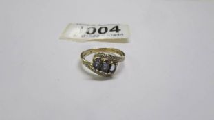 A 9ct gold three stone aqua ring with diamonds, size P, 2.5 grams.