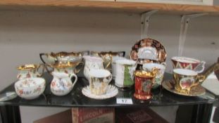 A mixed lot of teaware including sugar bowls, milk jugs, Royal Albert cup & saucer, souvenir cups.