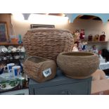 A large wicker round planter and 2 others