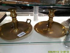 A pair of brass chamber candlesticks.