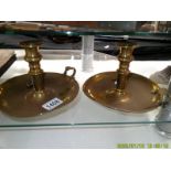 A pair of brass chamber candlesticks.