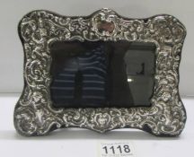 A silver photo frame, 20 x 14 cm.