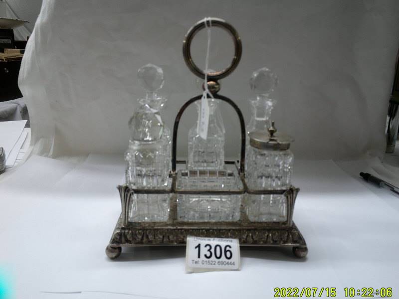 A six bottle condiment set on silver plate stand.