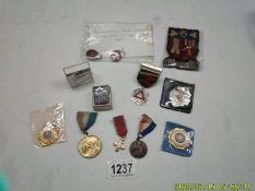 A small collection of badges and medals including Silver safe driving medal, WVS badge etc.,