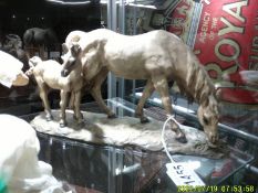 A mare with foal figure.