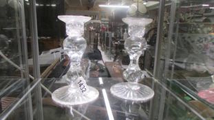 A pair of cut glass candlesticks.