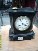 A black slate mantel clock.