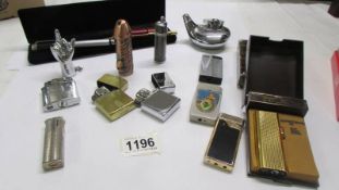 A collection of cigarette lighters including Zippo, novelty and two old pens.