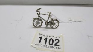 A small silver bicycle.