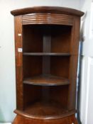 A 1930's oak open front corner cupboard