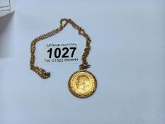 A 1912 sovereign in a pond cut mount on a 9ct gold chain, total weight 14.3 grams