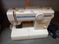 A vintage Toyota sewing machine with foot pedal and cover
