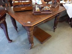 An oak wind out table with extra leaf