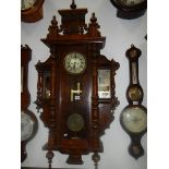 An ornate Victorian twin weight Vienna wall clock with mirrored adornments. COLLECT ONLY.