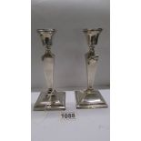 A pair of silver candlesticks, 18 cm tall.