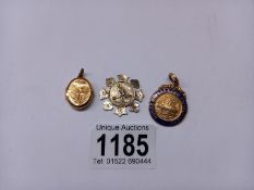 A 9ct gold medal dated Birmingham 1950, another medal dated Birmingham 1896 and a 9ct gold locket.