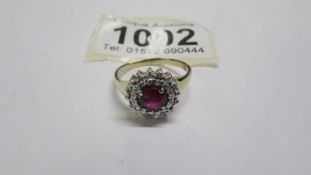 A yellow gold red sapphire and diamond ring, size P. 2.8 grams.