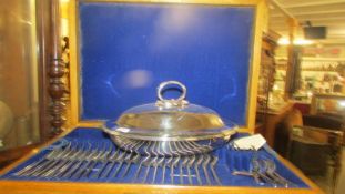 A part canteen of cutlery and a silver plate tureen.