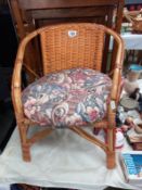 A small wicker chair with cushion