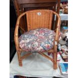 A small wicker chair with cushion