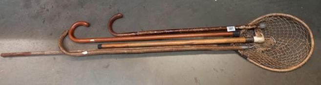 A vintage fishing landing net, hook and 2 walking sticks